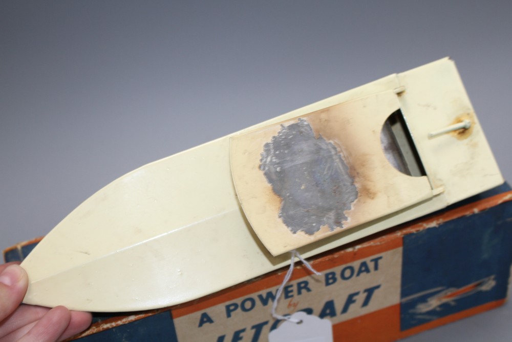 A boxed Jetex plastic fuel propelled model boat, a Jetcraft tinplate burner propelled model power boat and a boxed Mechanex pressed foi